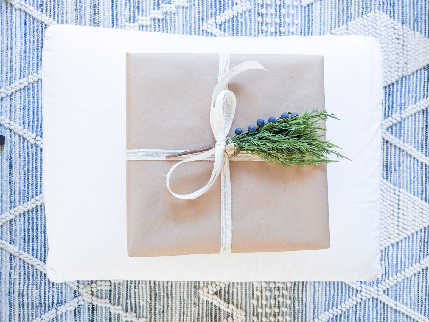 present wrapped with brown kraft paper and white bow