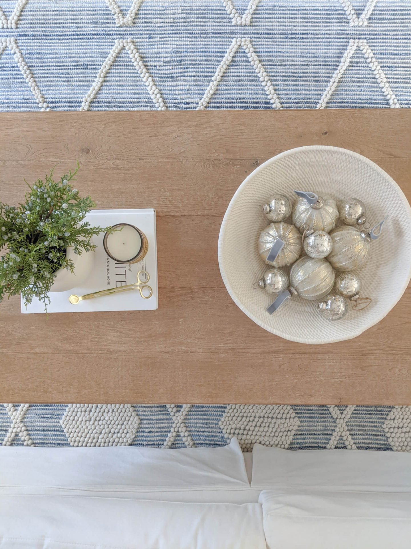 silver ornaments in a bowl on a coffee table