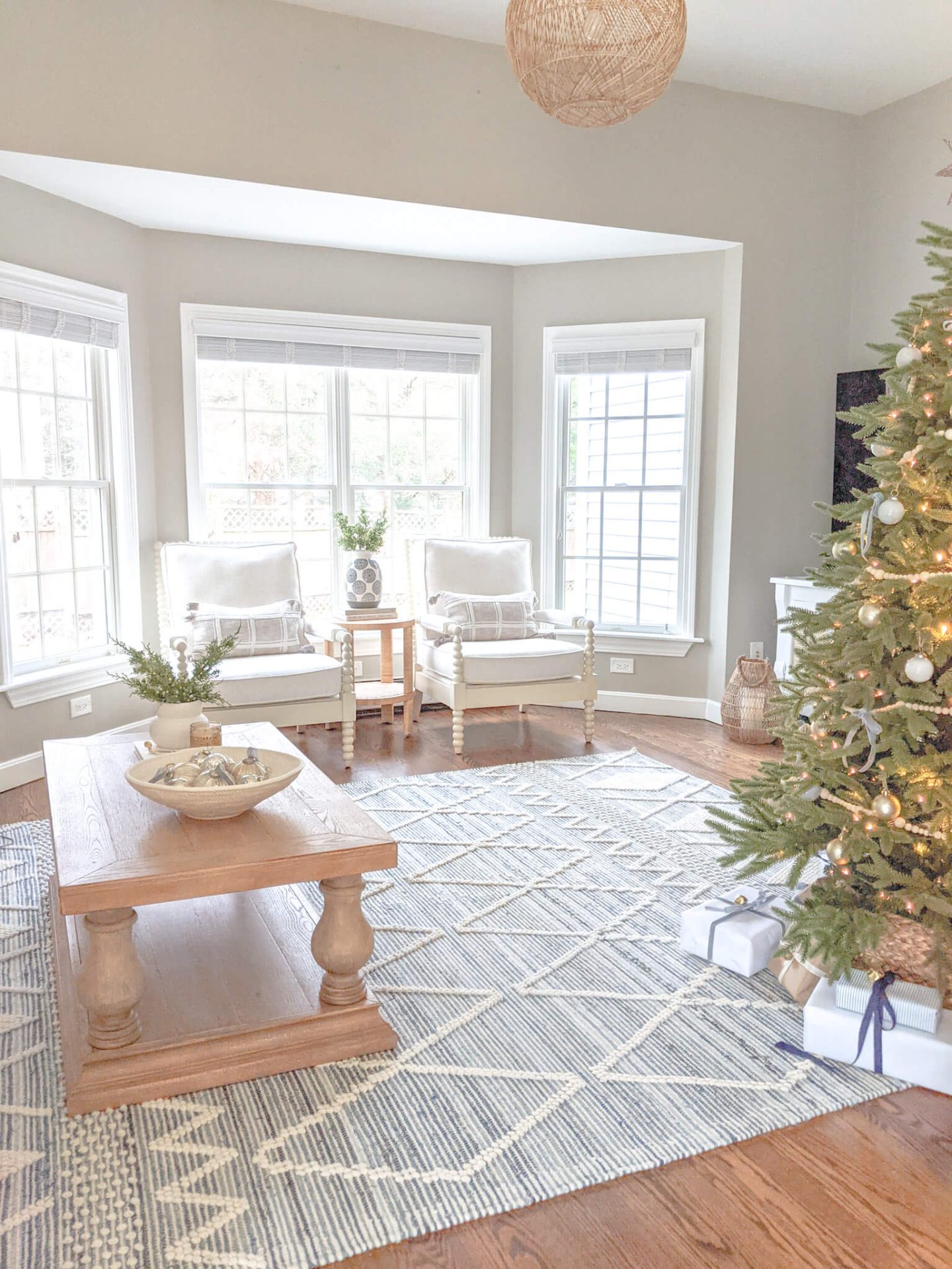 coastal living room with christmas tree and wrapped presents underneath