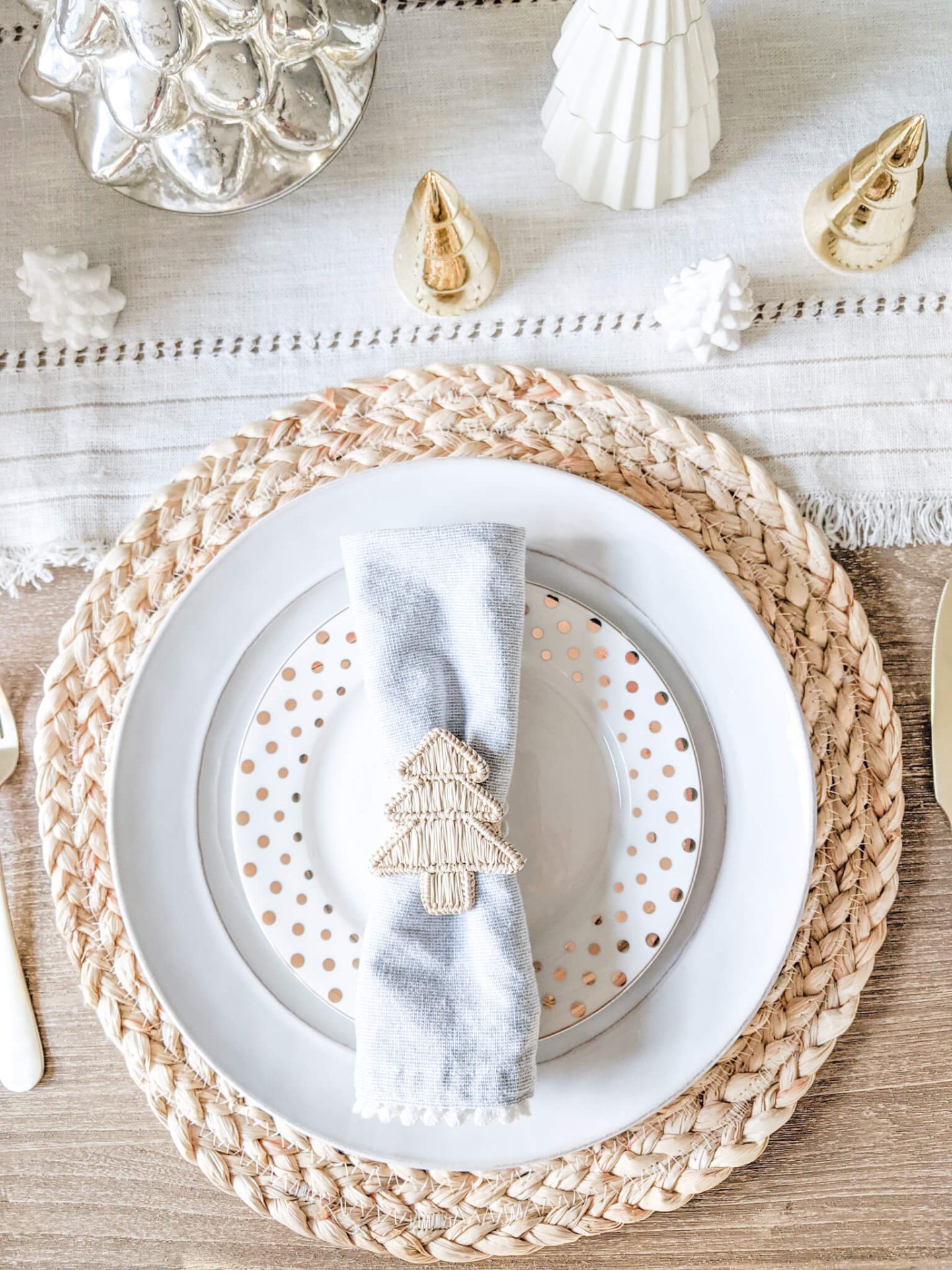 white plates with woven placemats with wood christmas tree napkin ring
