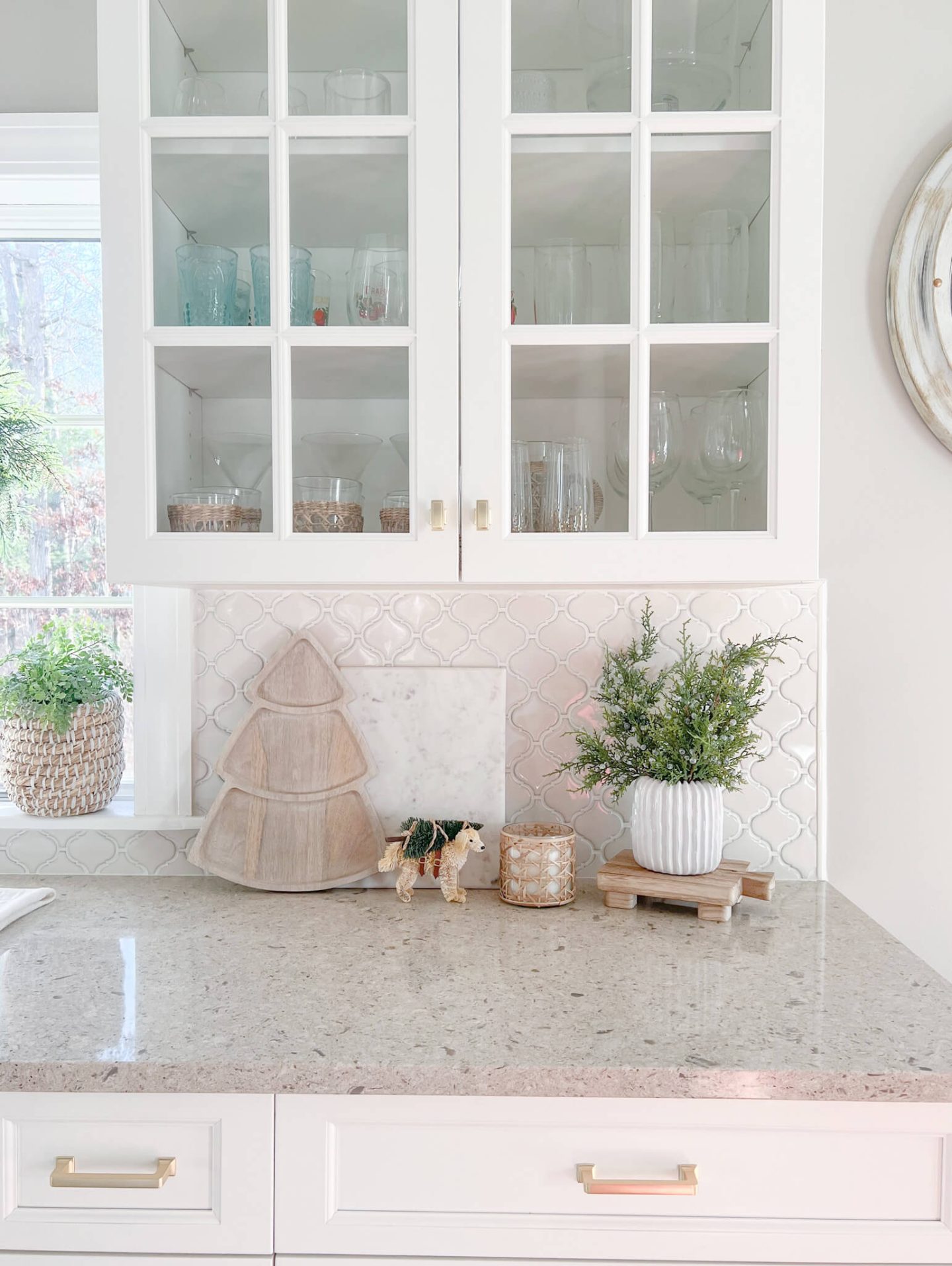 small greenery in kitchen with white cabinets