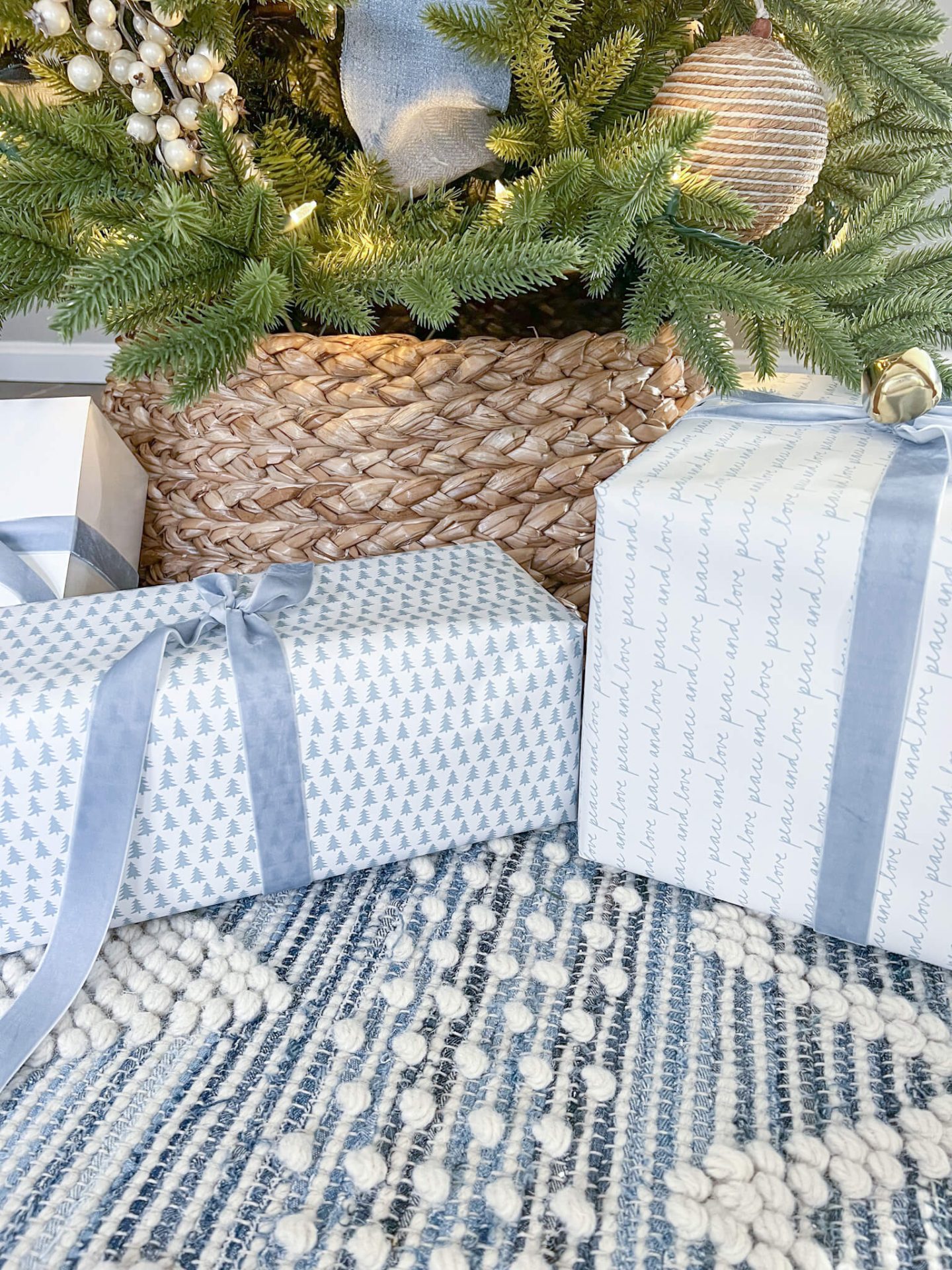closeup of wrapped christmas presents in light blue and white wrapping paper