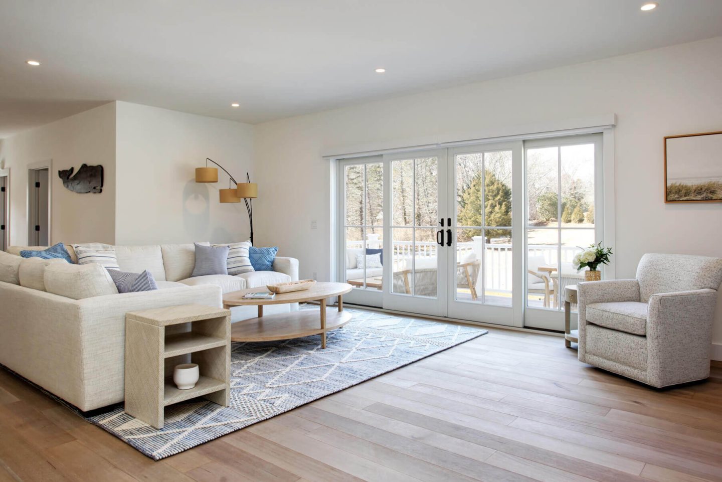 coastal style living room with oval whitewashed coffee table and white sectional