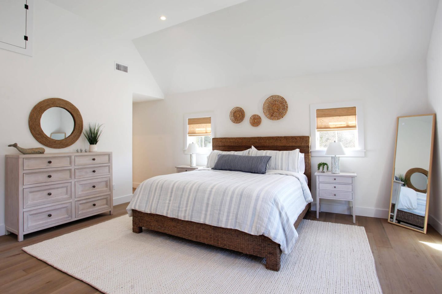 coastal bedroom with whitewashed wood dresser and white walls
