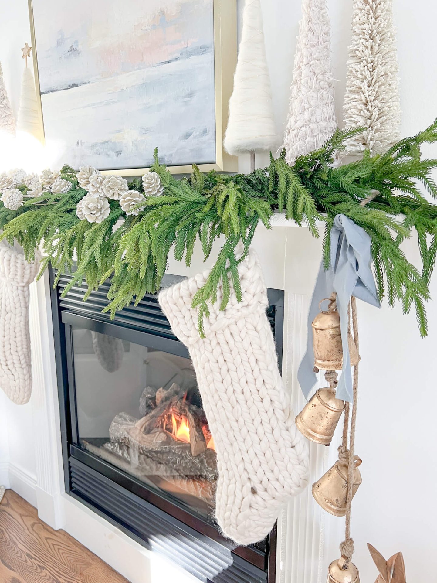 christmas mantel with white christmas trees on it